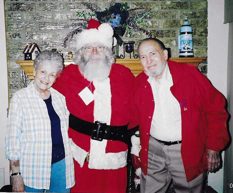 BAMOW volunteer dressed as Santa bringing holiday cheer to a client, 2004