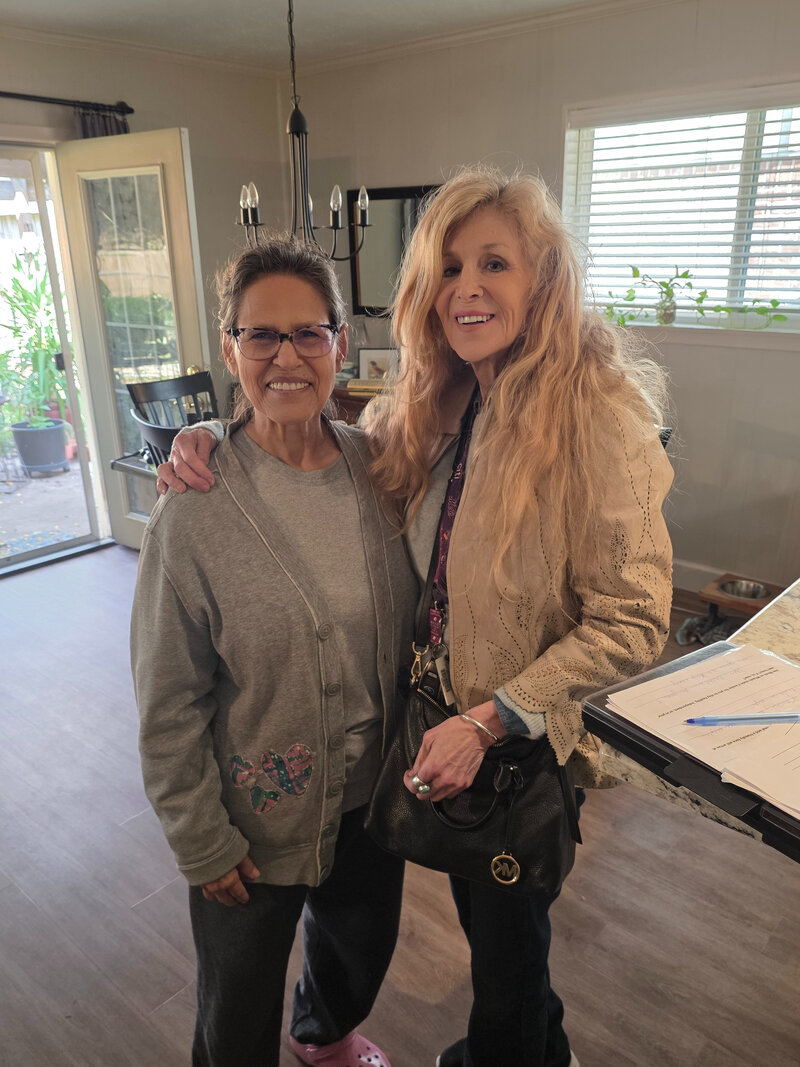 Aurora Caden with a Bay Area Meals on Wheels volunteer in her home