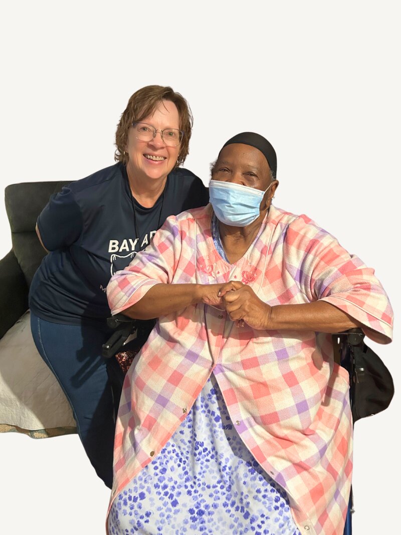 Sharon Reid-Carney with a Bay Area Meals on Wheels volunteer, both smiling